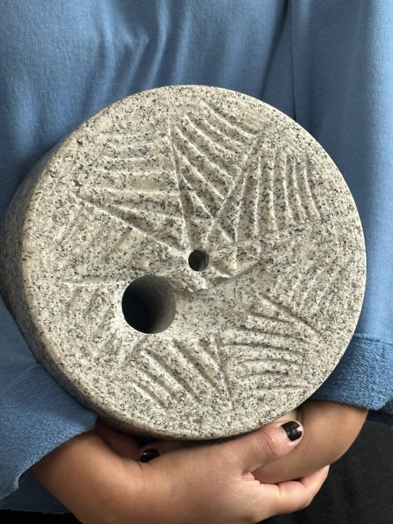 A grinding stone cut out to look like sourdough bread at Barton Springs Mill