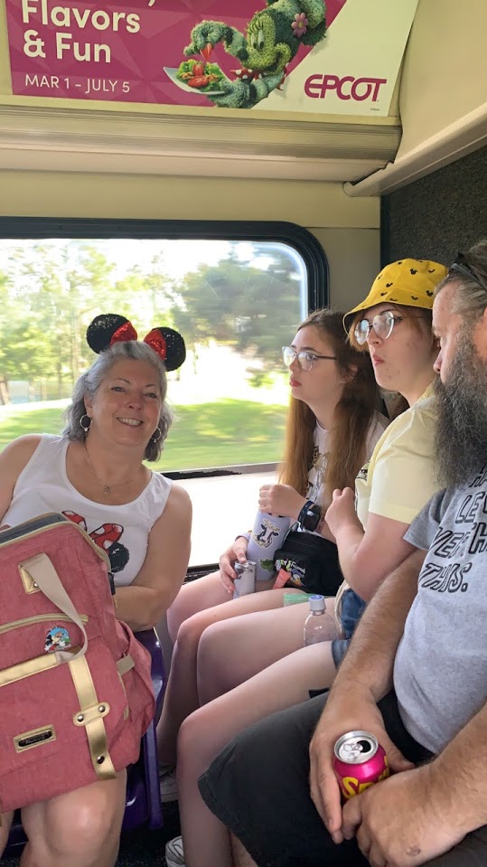 Three females, one male on a bus to Animal Kingdom