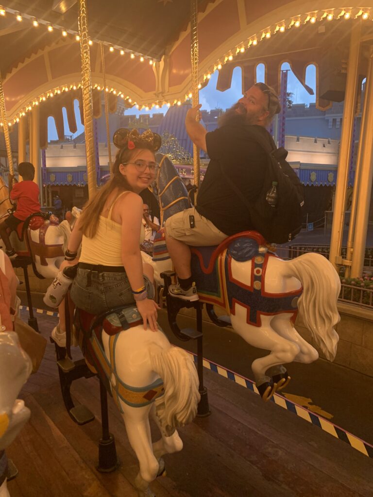 A father and daughter at the carousel in Magic Kingdom
