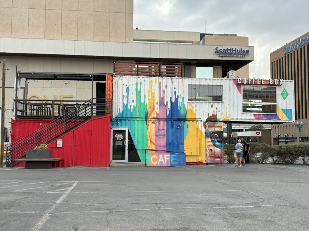 A container store with art on it and coffee inside of it!