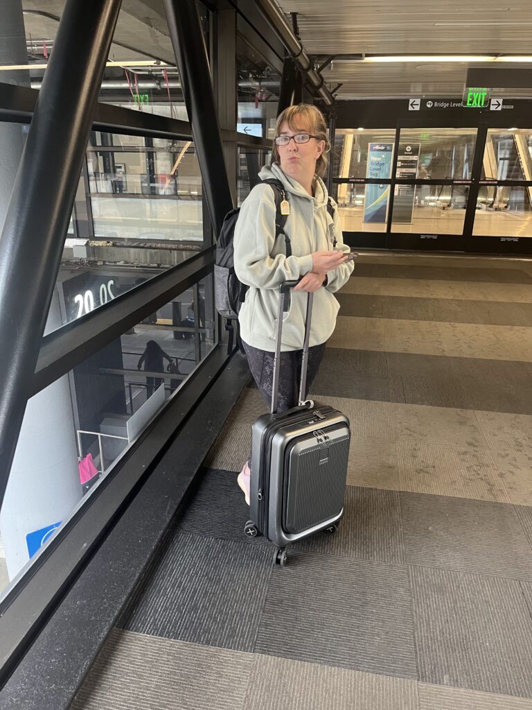 A picture of me with my luggage trying to help you learn how to pack with just a carry-on