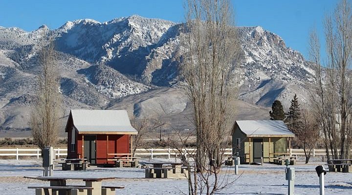 A couple of buildings in front of a mountain