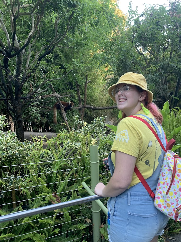 A girl in front of a red panda exhibit at the San Diego zoo