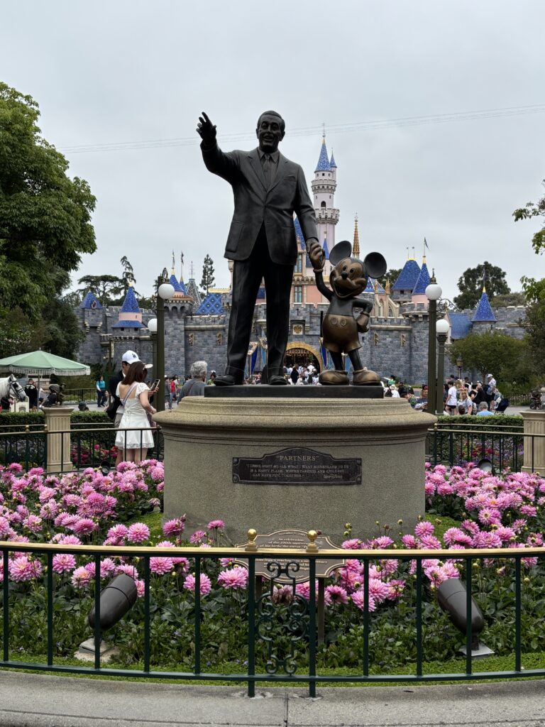 Walt Disney and Mickey statue in front of Sleeping Beauty's Castle