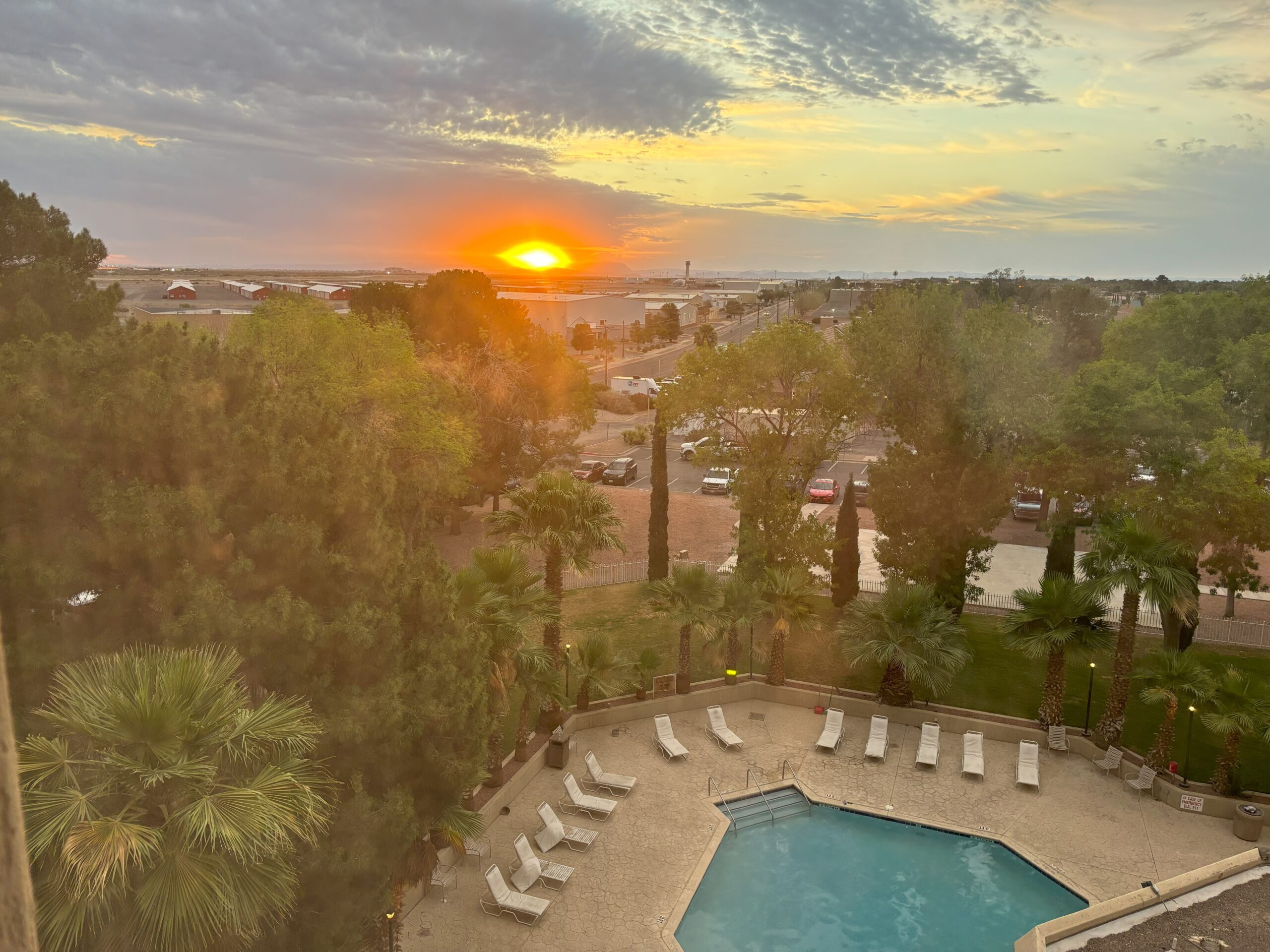 A picture of the pool overlooking a sunrise in El Paso.