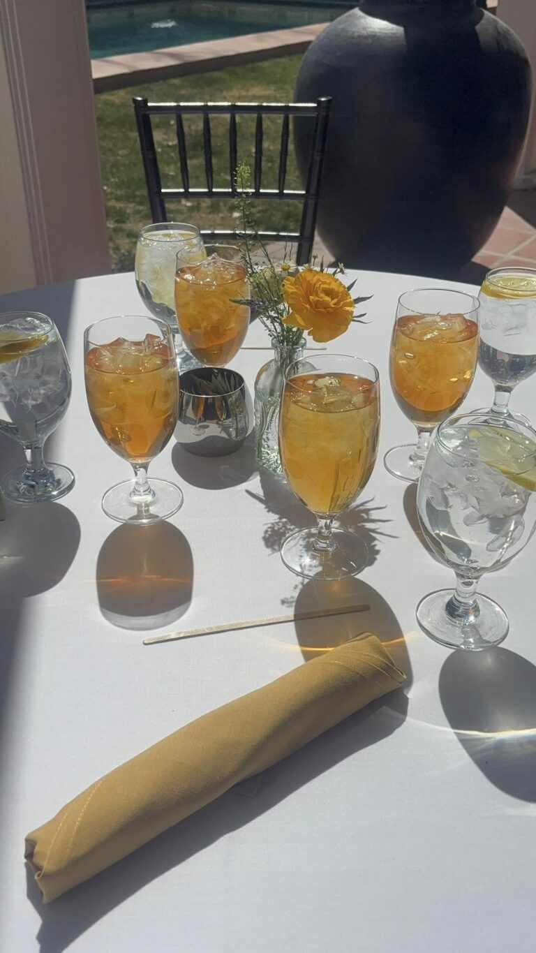 Four tea glasses around a table