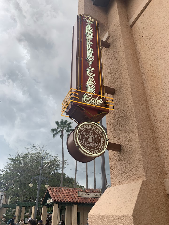 The Starbucks sign in Hollywood Studios- it looks very retro with beige coloring and palm trees in the background