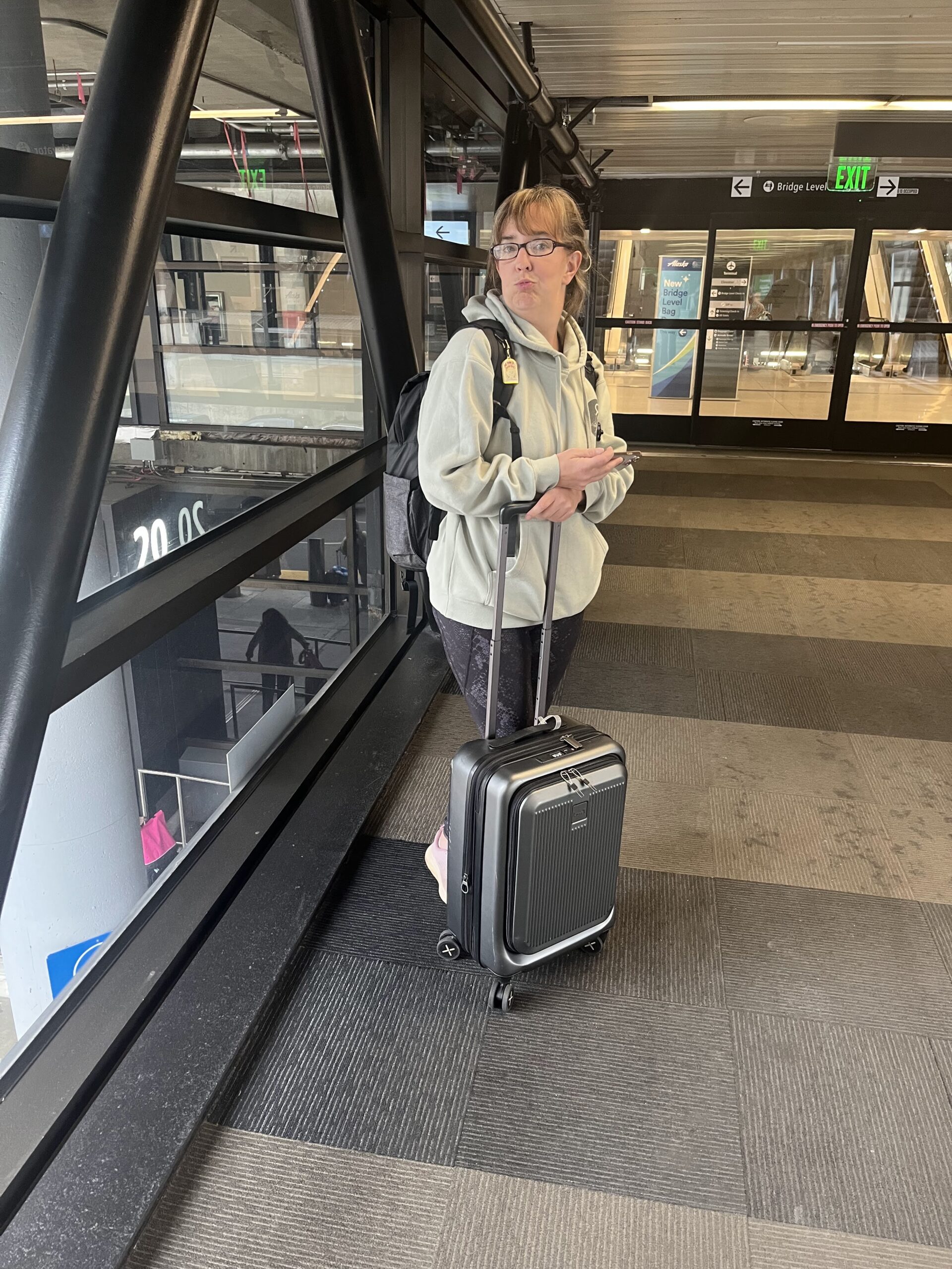 A picture of me with my luggage trying to help you learn how to pack with just a carry-on